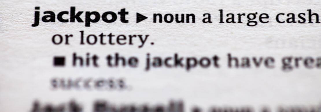 dictionary page opened to the word "hit the jackpot"