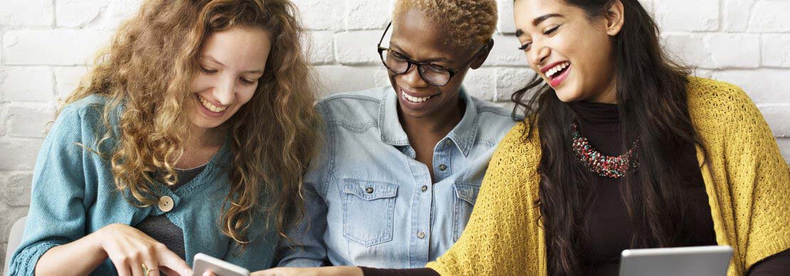 three women on their phone, laptop and tablet playing games at Jackpot Capital