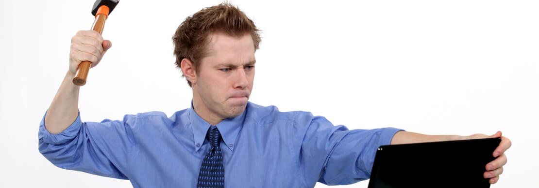 angry guy about to smash his laptop with a hammer