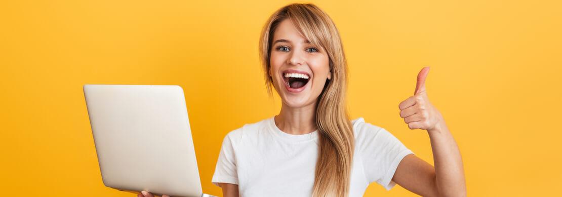 happy woman giving a thumbs up after winning playing at Jackpot Capital on her laptop