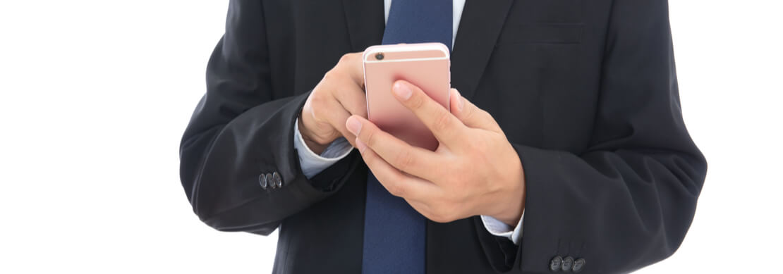 man in a suit playing video poker at Jackpot Capital on his phone