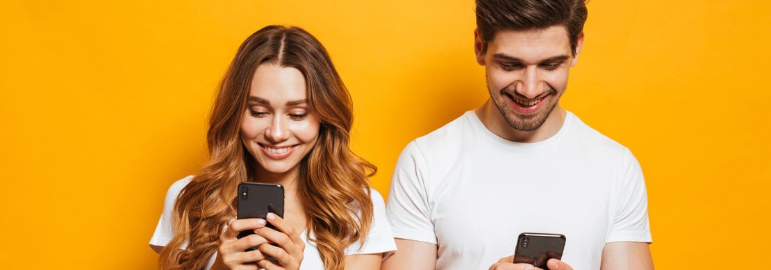 a young man and woman playing an online casino on their phones