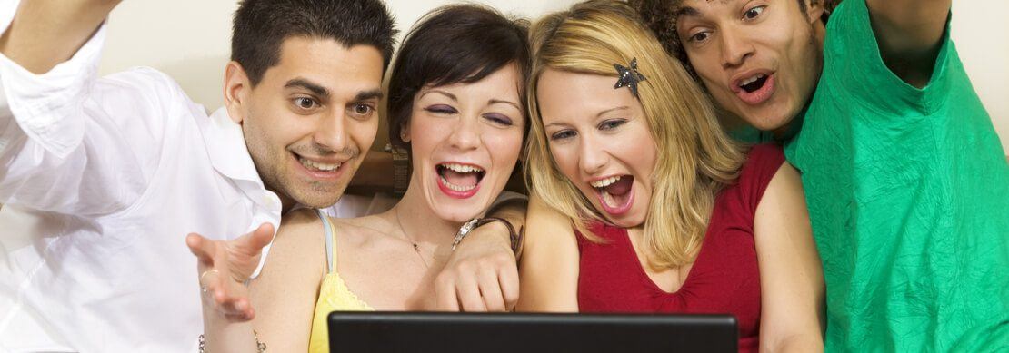 group of friends having fun on a laptop