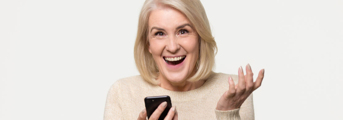 woman holding her phone very happy
