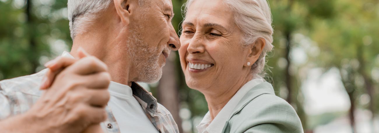 a close up of a very happy elderly coupler dancing