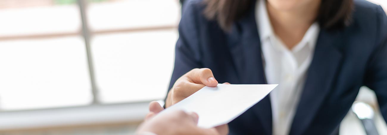 attractive young woman receiving a bonus from an employer or superior