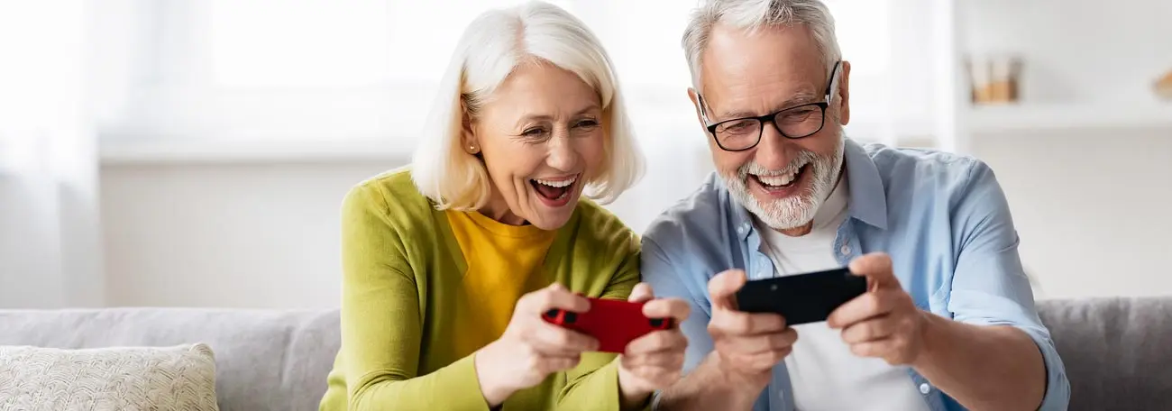 an older couple ecstatically playing a game on her phone