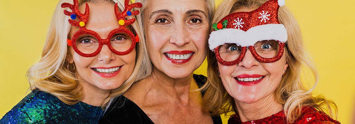 three older women having a great time together celebrating either a holiday or family event