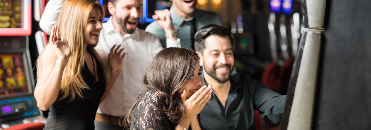 a group of friends having a great time playing slots together
