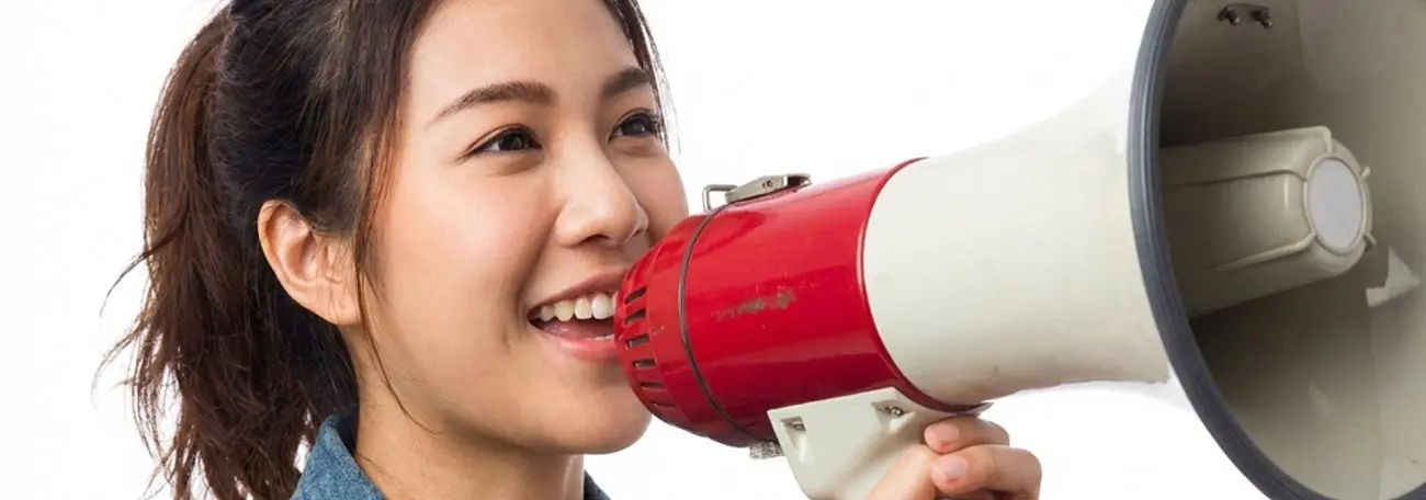 an attractive young woman promoting a product using a megaphone