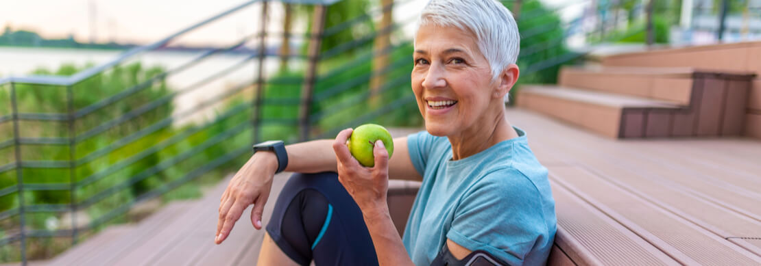healthy sporty woman eating an apple