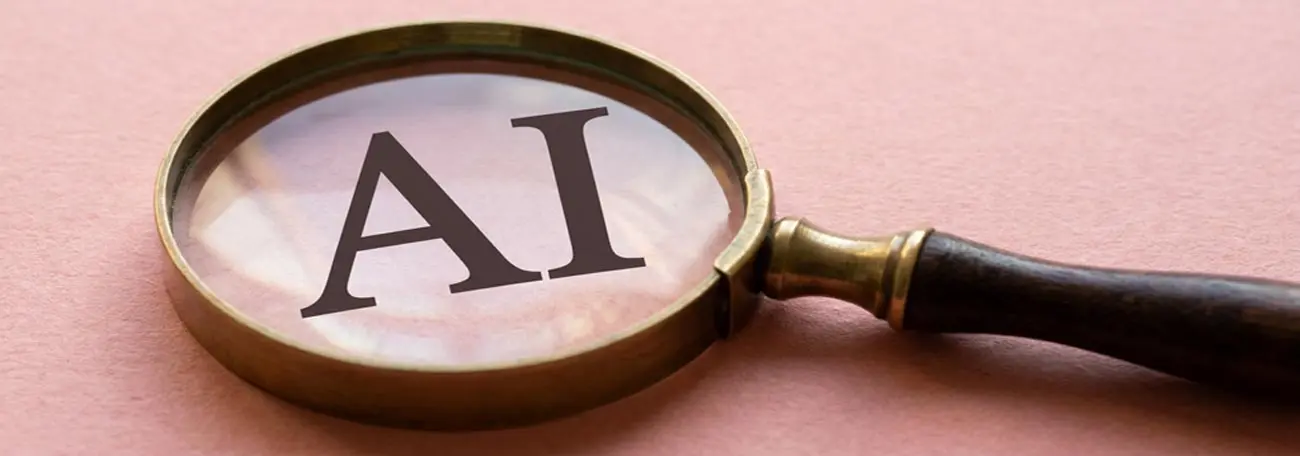the letters AI in caps under a magnifying glass on a pinkish background