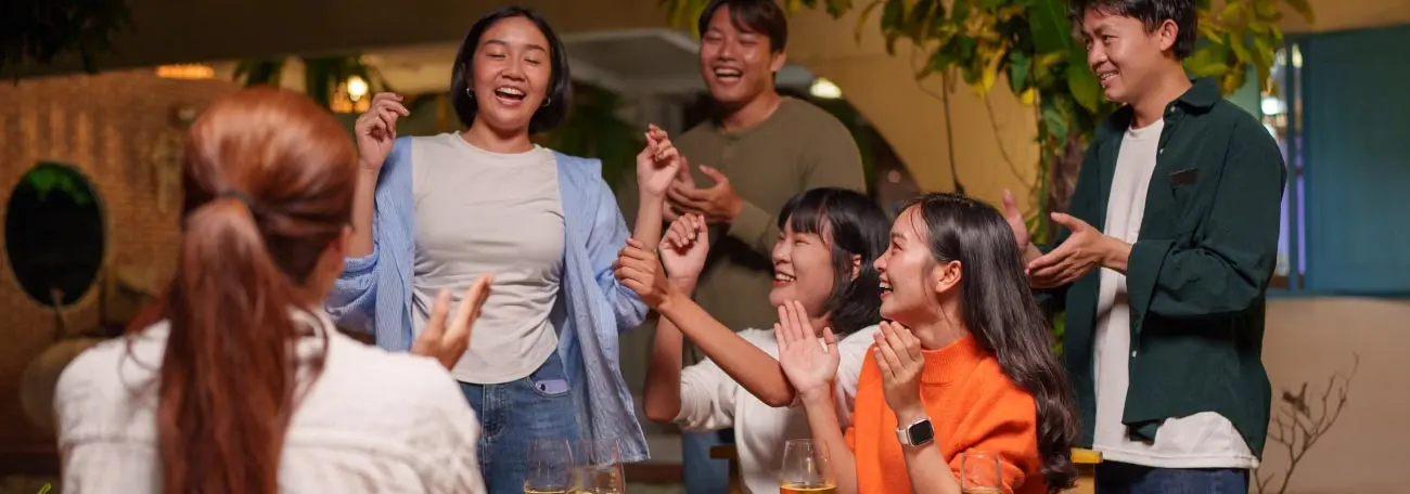 a group of six young adults enjoying an evening together demonstrating how friendships are a great bonus