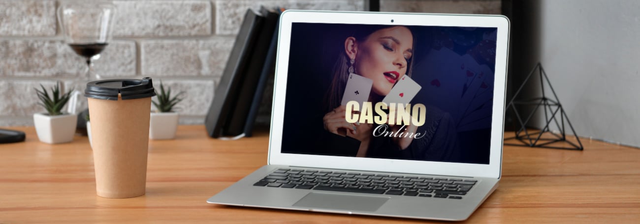 a woman on a laptop screen holding two aces with the words casino online beneath the cards. the setting is a country home 