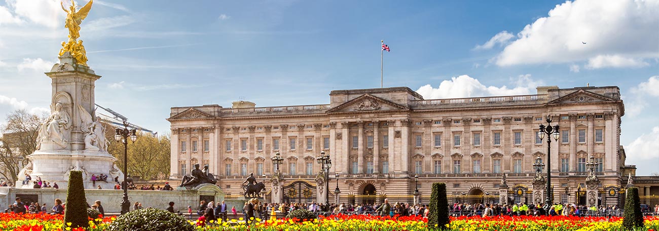 Buckingham Palace with the flowering gardens in the foreground.