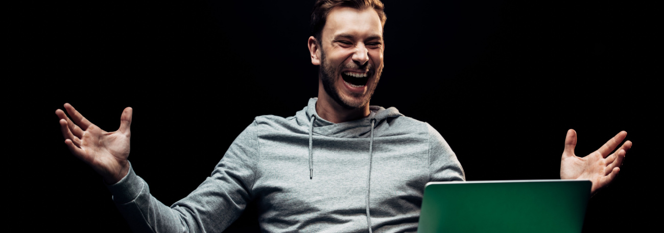 young man enjoying playing online casino games on laptop computer