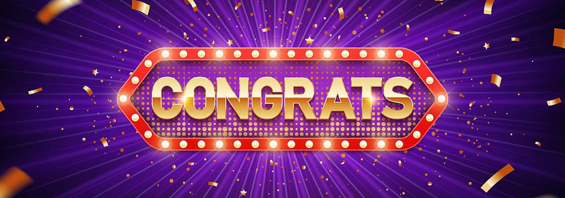 the word congrats in a retro sign with light bulbs that circle around the word. Behind congrats are pieces from the 