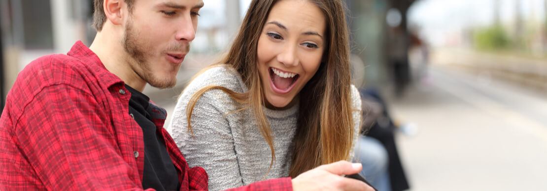 happy couple playing Jackpot Capital games on their phone together