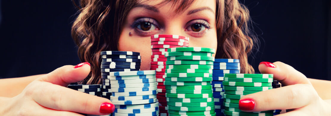 woman with piles of casino chips in front of her