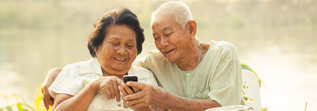 senior couple playing on a mobile at Jackpot Capital