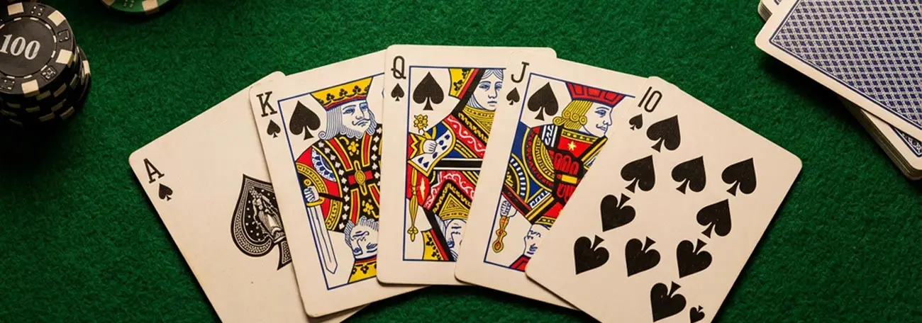 a royal flush in hearts set against a green felt background