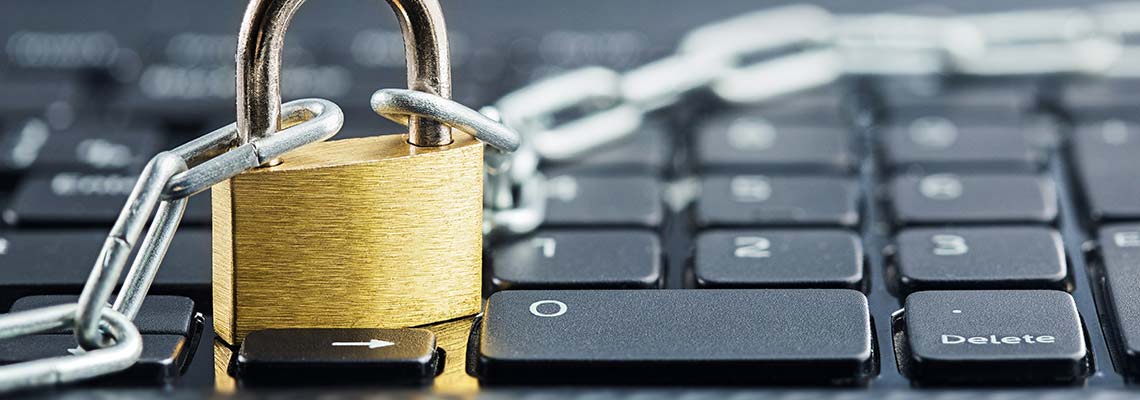 a computer keyboard with a padlock and chain resting on top of it as a symbol of the security measures internet sites use