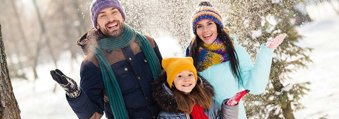 happy family enjoying a snowy weekend vacation