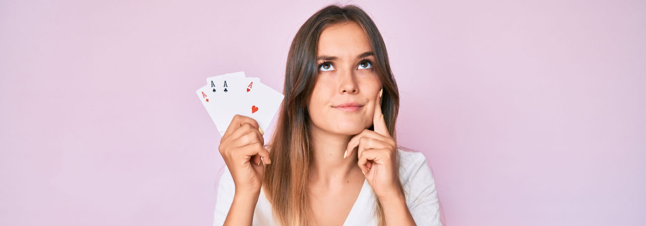 a young woman with long light brown hair playing a card game in deep thought