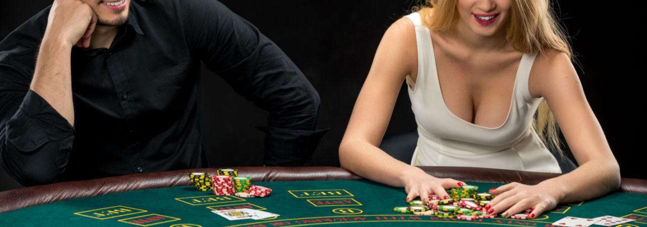 a man and a woman playing poker and giving the hand a lot of thought. The woman is about to go all in.